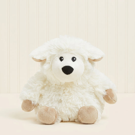 Plush toy resembling a white creature with black eyes and a black nose on a beige background