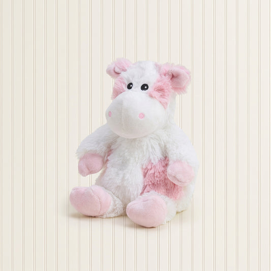 White and pink plush toy on a light gray background