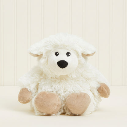 A small white plush sheep toy with beige paws and ears, black embroidered eyes, and a black nose, sitting against a plain cream background.