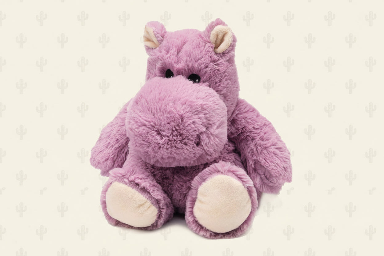 Plush hippo toy with pink fur and white paws on a white background